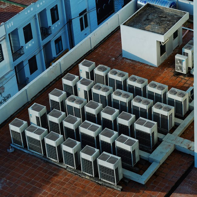 Commercial rooftop air-conditioning units silhouetted against a desert sky.