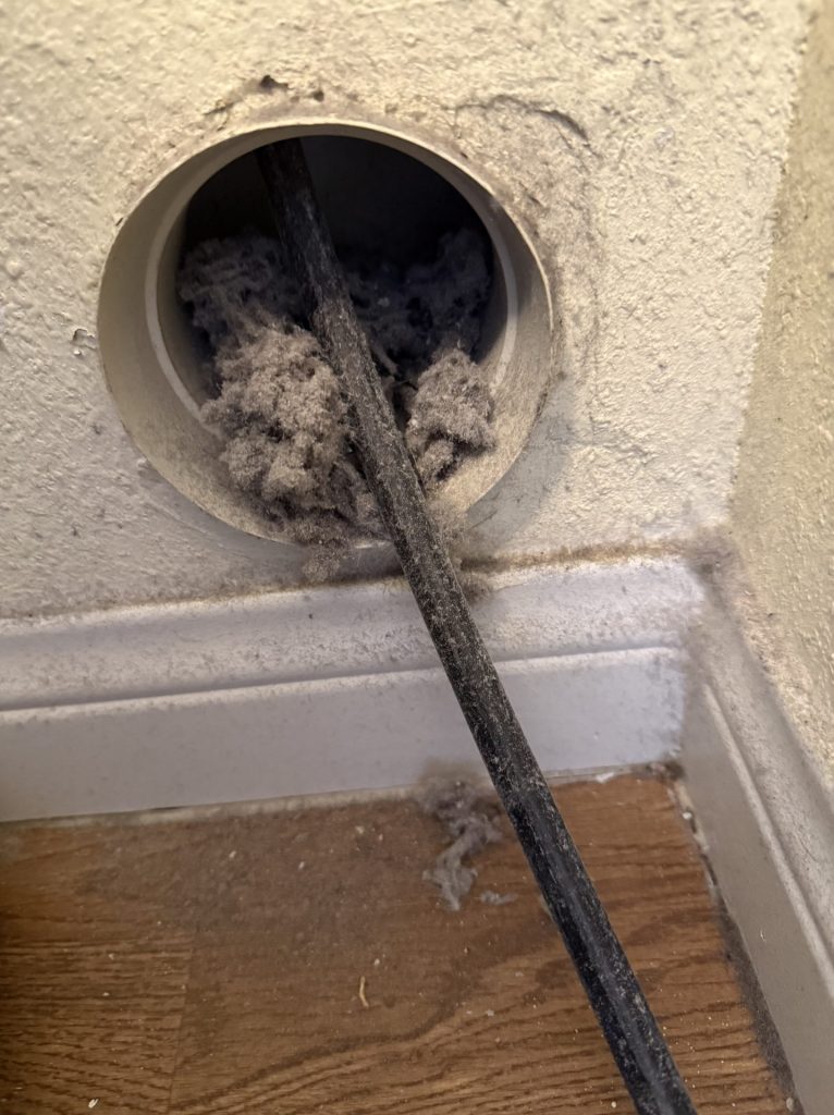 Edgar's Service technician performing a full-run dryer vent cleaning in Las Vegas